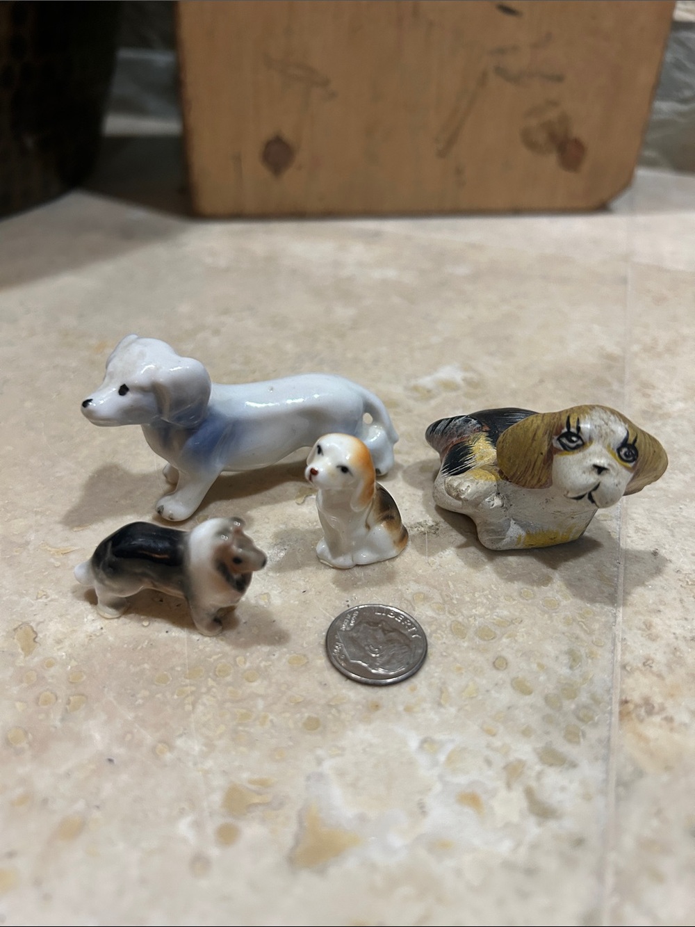 4 vintage, hand-painted ceramic or porcelain miniature dog figurines